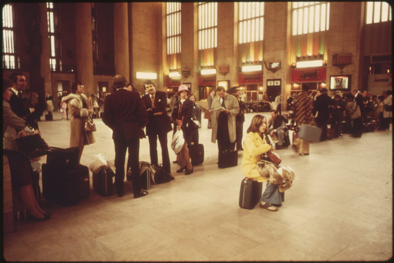 AMTRAK PASSENGERS LINED UP WAITING FOR A FRIDAY AFTERNOON TRAIN AT THE 30TH STREET STATION IN PHILADELPHIA. IT IS ONE OF FOUR OR FIVE STOPS MADE BY THE METROLINERS WHICH MAKE 16 ROUND TRIPS EACH DAY…, 1974, Philadelphia