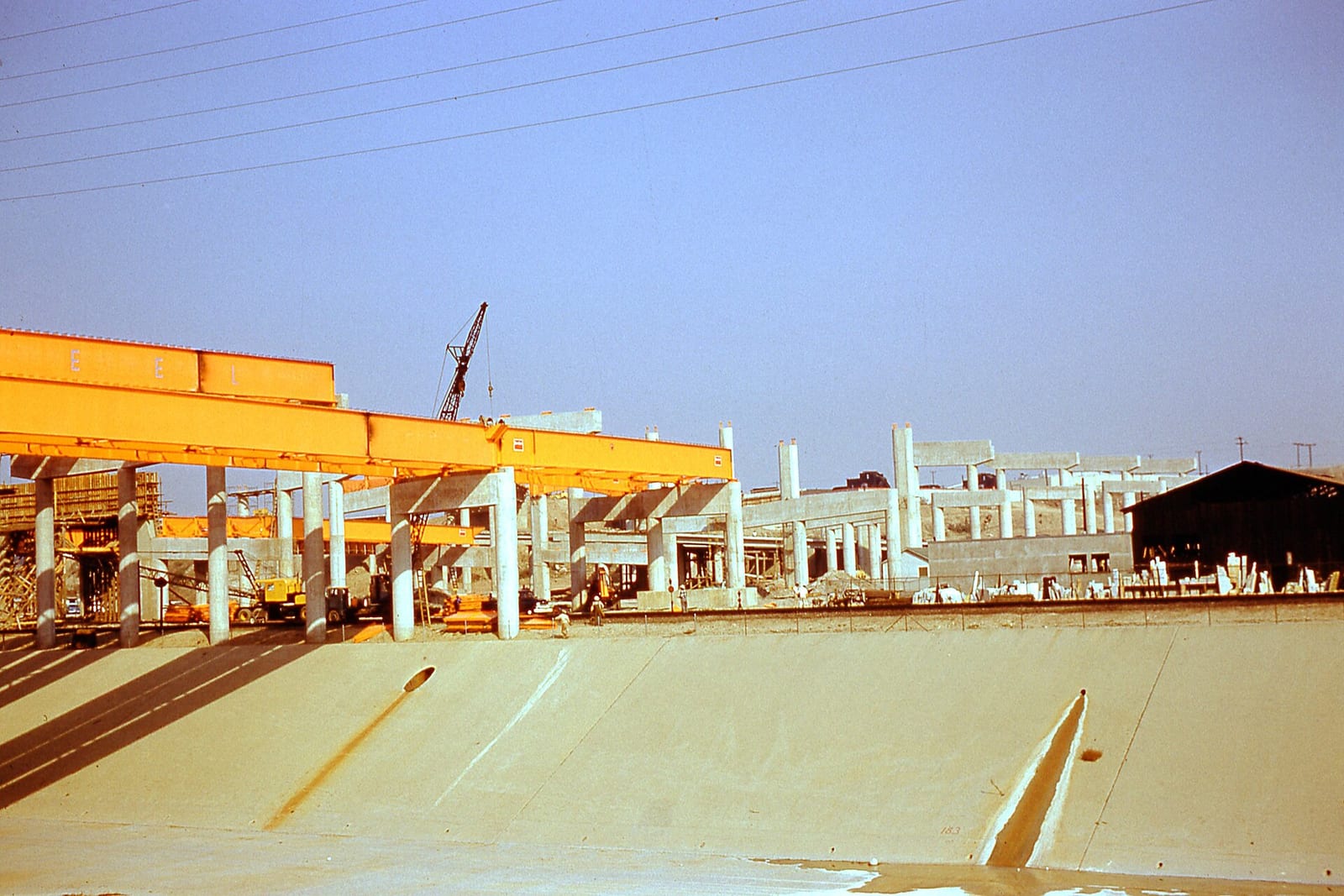 Photograph of East LA Interchange - LA River Bridge construction 1959. View across L.A. River "1-29-59 Winkler", 1959, Los Angeles