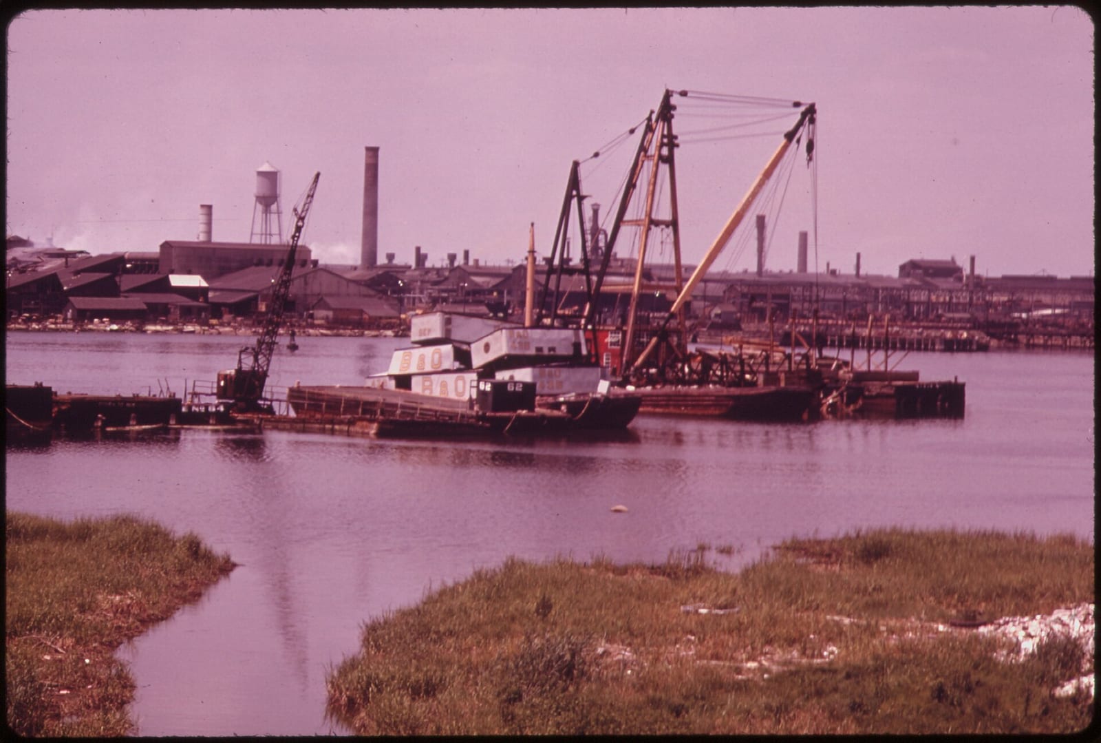ARTHUR KILL ROAD ON, LOOKING NORTH. THIS IS AN AREA OF HIGH DENSITY PETROCHEMICAL SHIPPING AND INDUSTRY, WITH AN ATTENDANT HIGH LEVEL OF POLLUTION, 1973, New York City