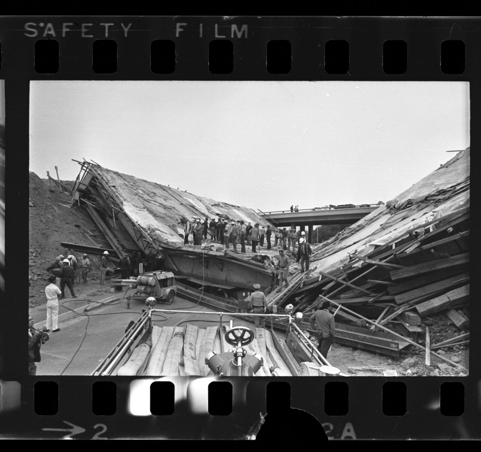 Emergency and construction workers on collapsed bridge on the San Bernardino and San Gabriel River Freeways, Los Angeles, 1970, 1970, Los Angeles